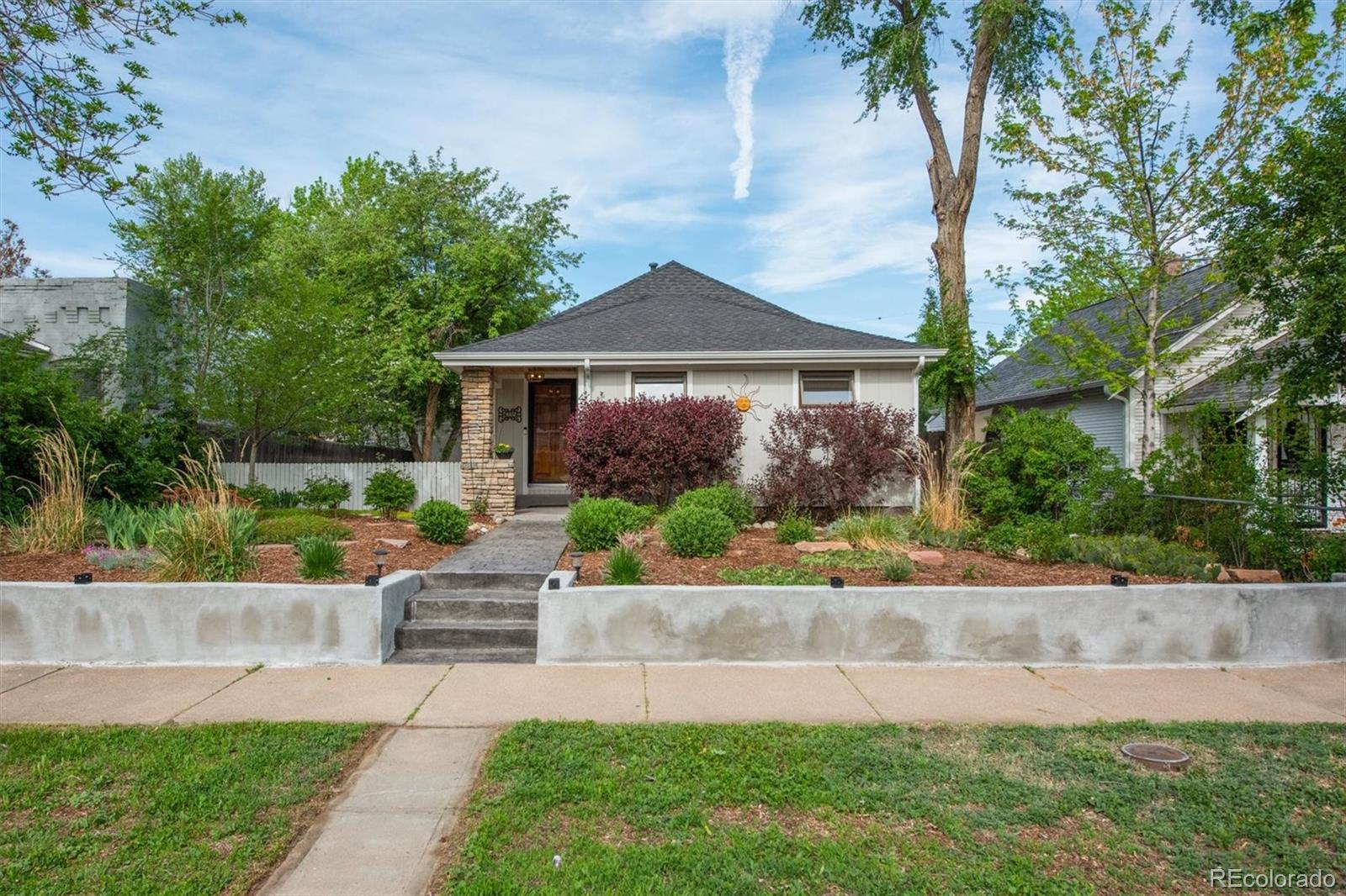 4335 Zenobia Street Denver, CO 80212 - Photo 25 of 26 a front view of a house with a yard and potted plants