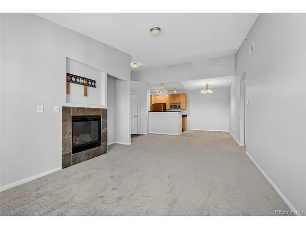 a view of empty room with a fireplace
