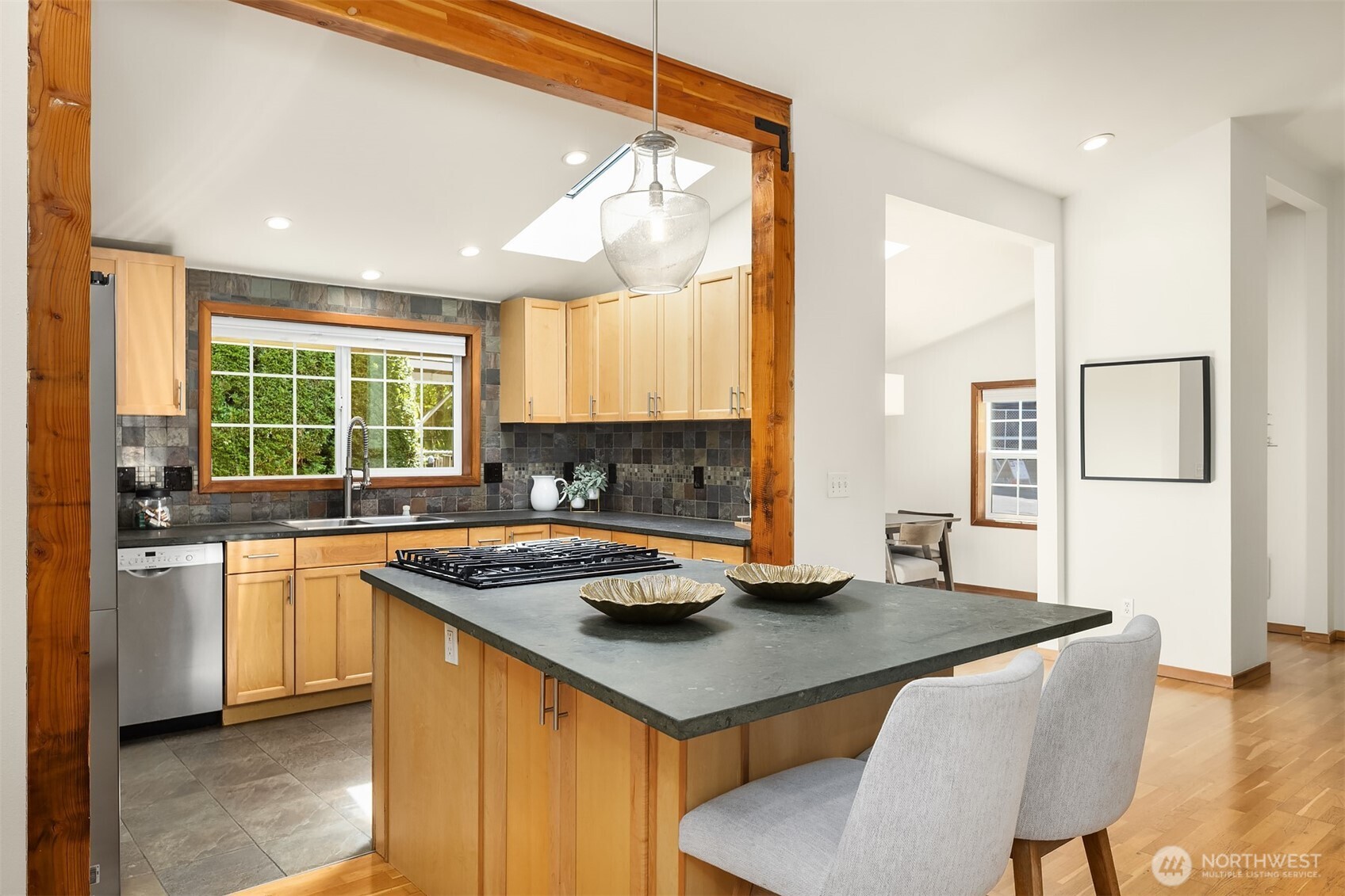 537 30th Avenue East Seattle, WA 98112 - Photo 11 of 25 a kitchen with stainless steel appliances granite countertop a stove a sink dishwasher and a refrigerator with wooden floor