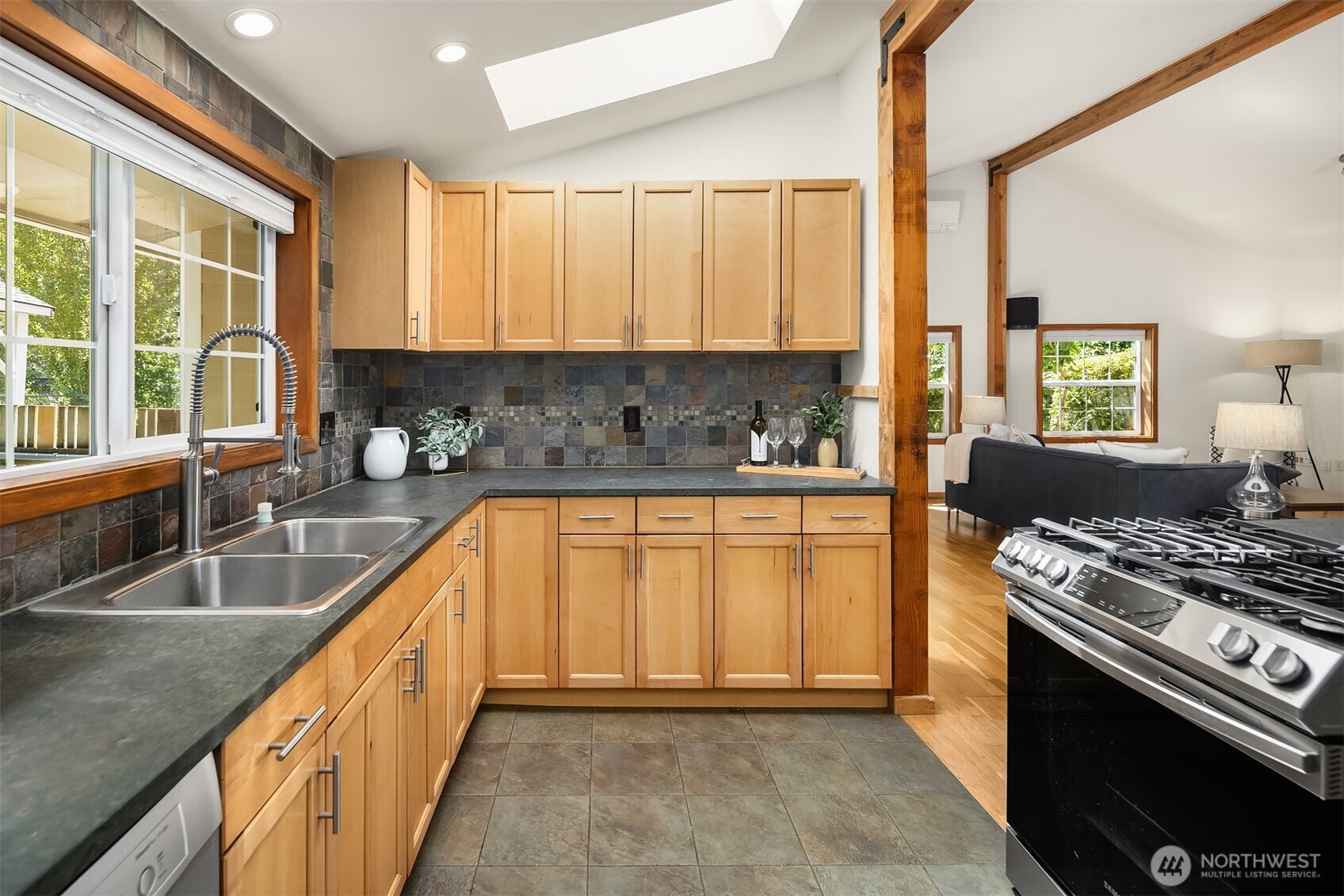 537 30th Avenue East Seattle, WA 98112 - Photo 10 of 25 a kitchen with a stove a sink and a granite counter top