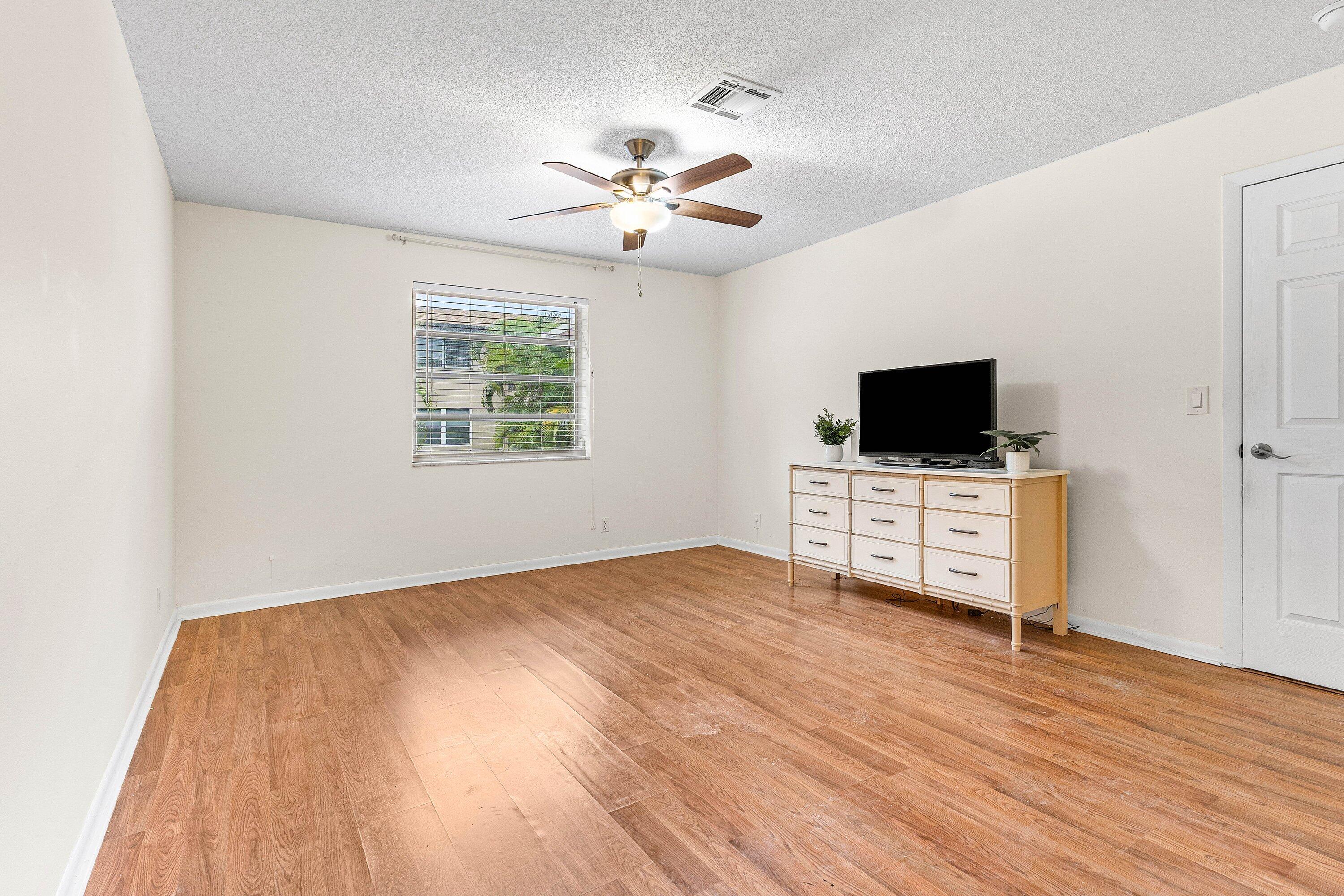 13899 Via Aurora, Unit C Delray Beach, FL 33484 - Photo 23 of 39 a view of room with flat screen tv