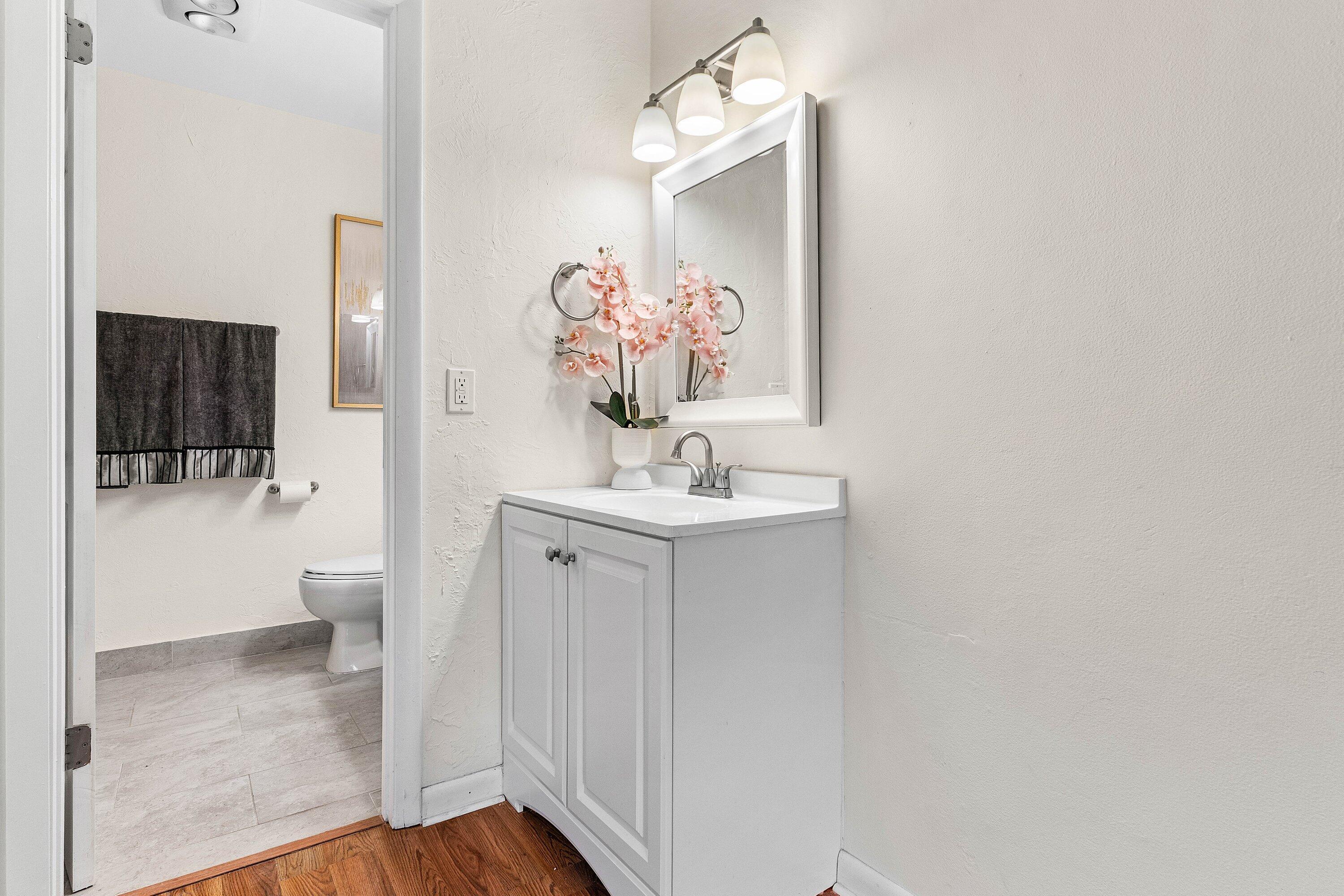 13899 Via Aurora, Unit C Delray Beach, FL 33484 - Photo 25 of 39 a bathroom with a sink a toilet and mirror
