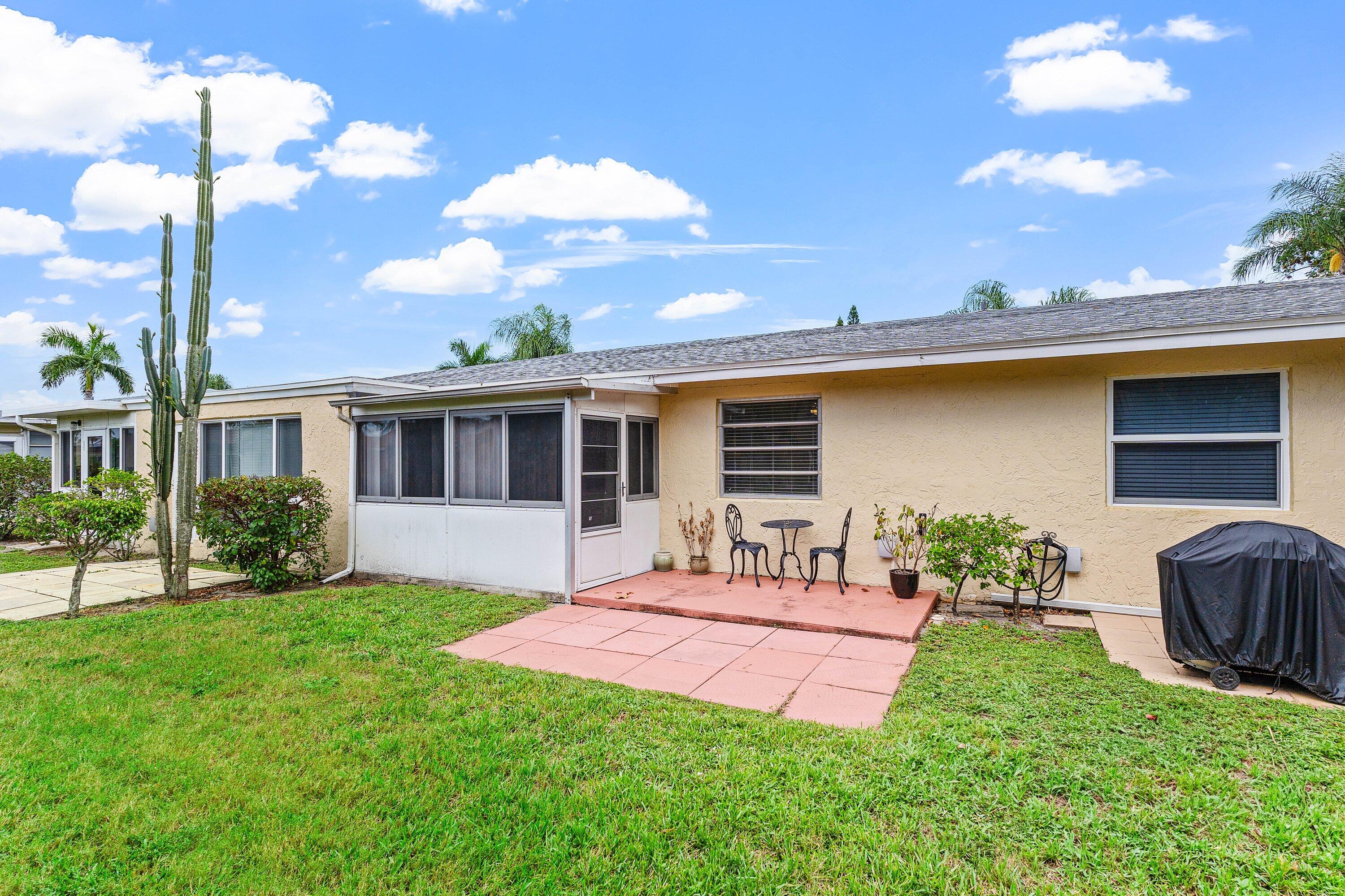 13899 Via Aurora, Unit C Delray Beach, FL 33484 - Photo 31 of 39 a front view of a house with a yard