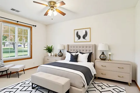 a bedroom with a bed and a window