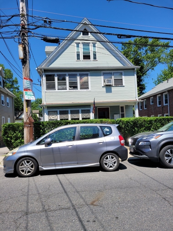 a front view of a house with parking space