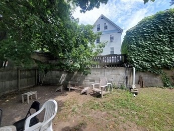 230 Corey Road Boston, MA 02135 - Photo 13 of 13 a backyard of a house with barbeque oven and outdoor seating