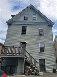 230 Corey Road Boston, MA 02135 - Photo 3 of 13 a front view of a house with balcony