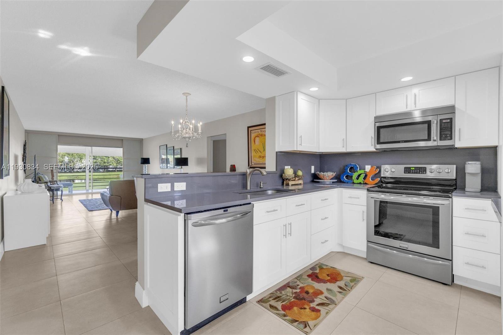 a kitchen with stainless steel appliances granite countertop a stove top oven a sink a counter top space and cabinets