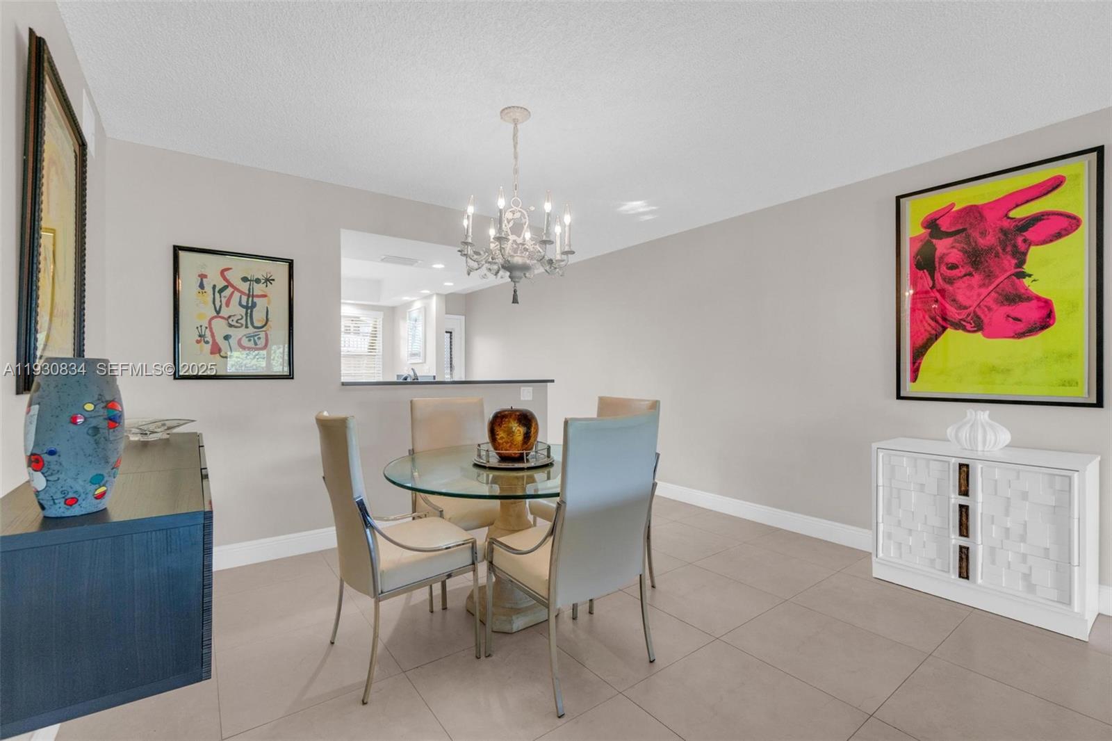 4402 Martinique Court, Unit K2 Coconut Creek, FL 33066 - Photo 11 of 38 a view of a dining room with furniture and chandelier
