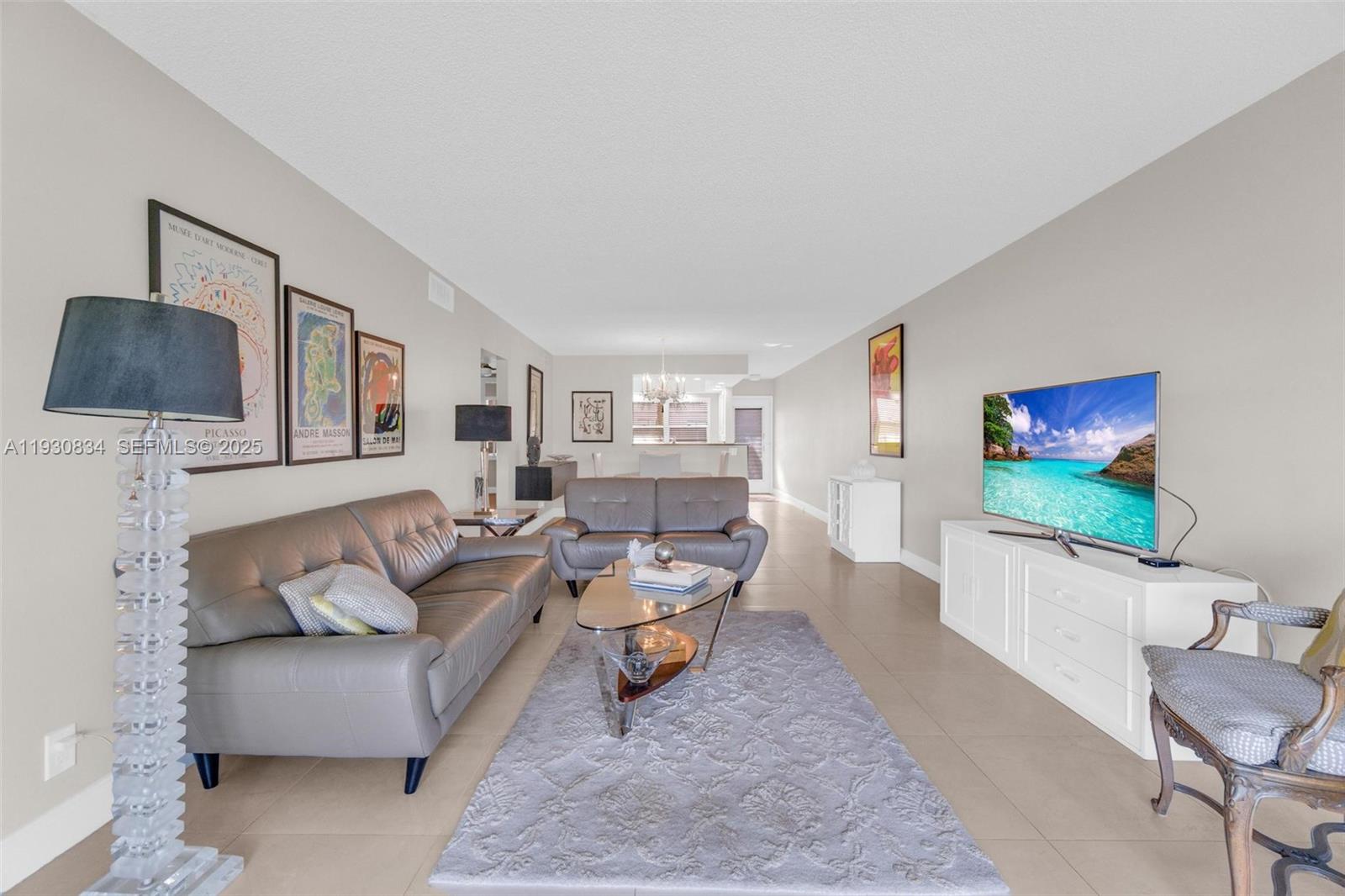 4402 Martinique Court, Unit K2 Coconut Creek, FL 33066 - Photo 13 of 38 a living room with furniture and a flat screen tv