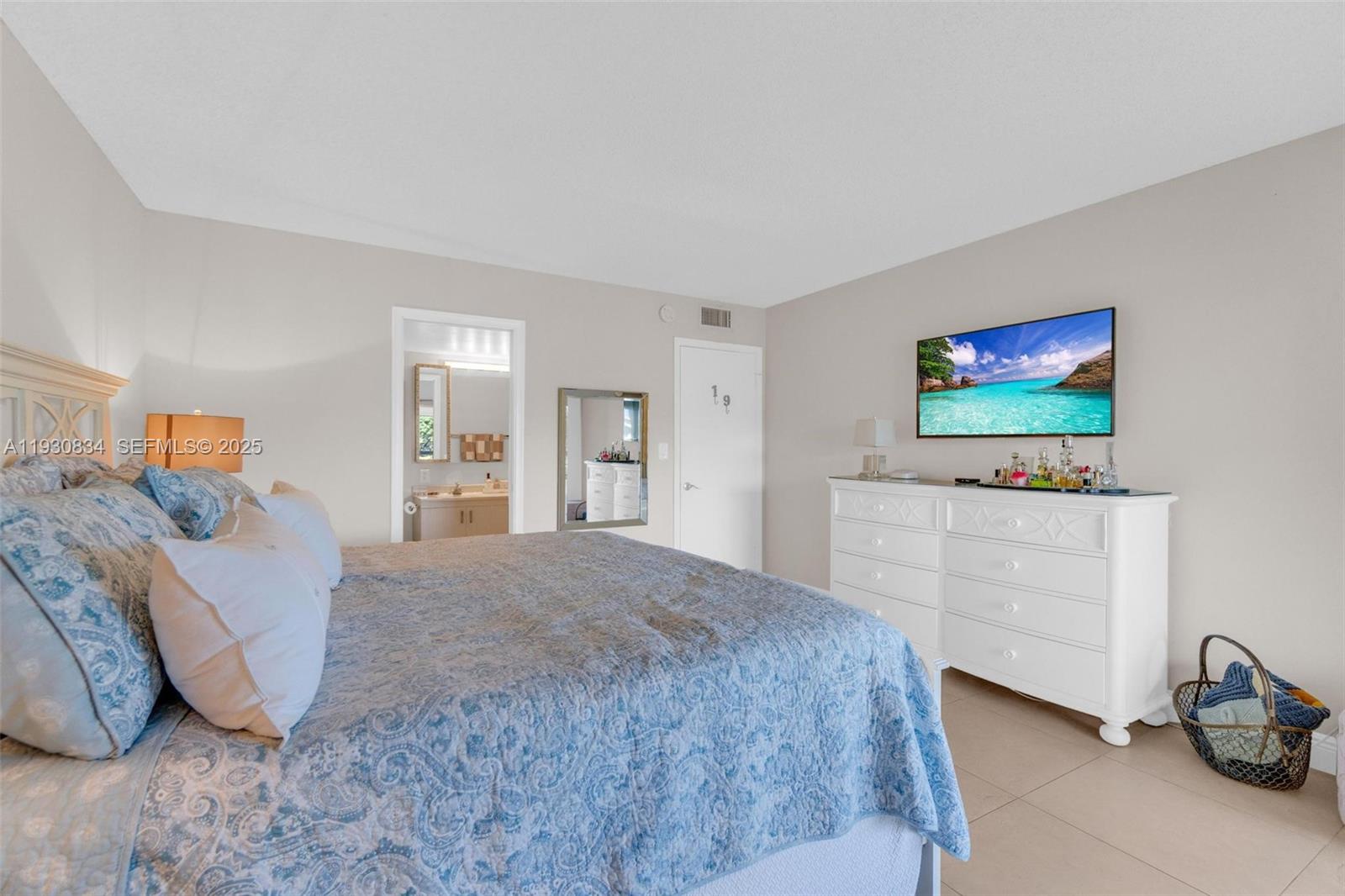 4402 Martinique Court, Unit K2 Coconut Creek, FL 33066 - Photo 18 of 38 a bedroom with a bed and a flat screen tv