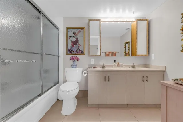 a bathroom with a sink toilet vanity and shower