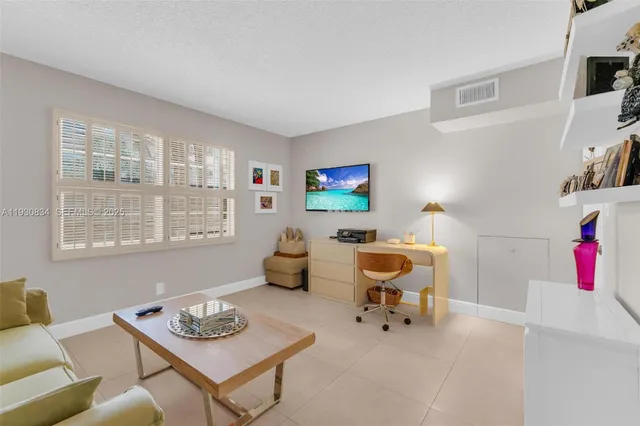 a living room with furniture and next to a window
