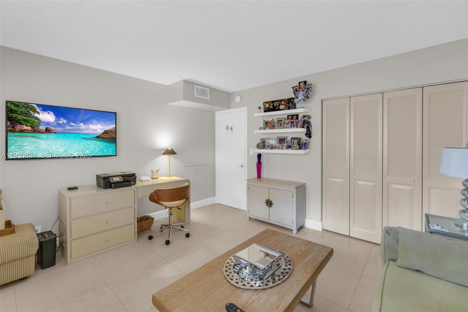 4402 Martinique Court, Unit K2 Coconut Creek, FL 33066 - Photo 25 of 38 a room with furniture and a flat screen tv