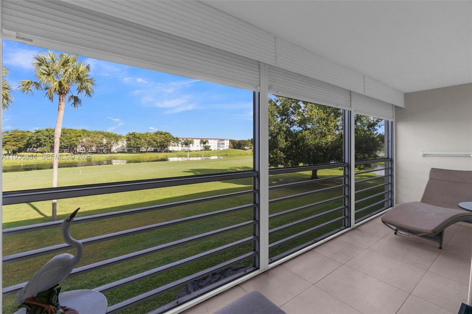 4402 Martinique Court, Unit K2 Coconut Creek, FL 33066 - Photo 28 of 38 a view of a chairs and table in the balcony