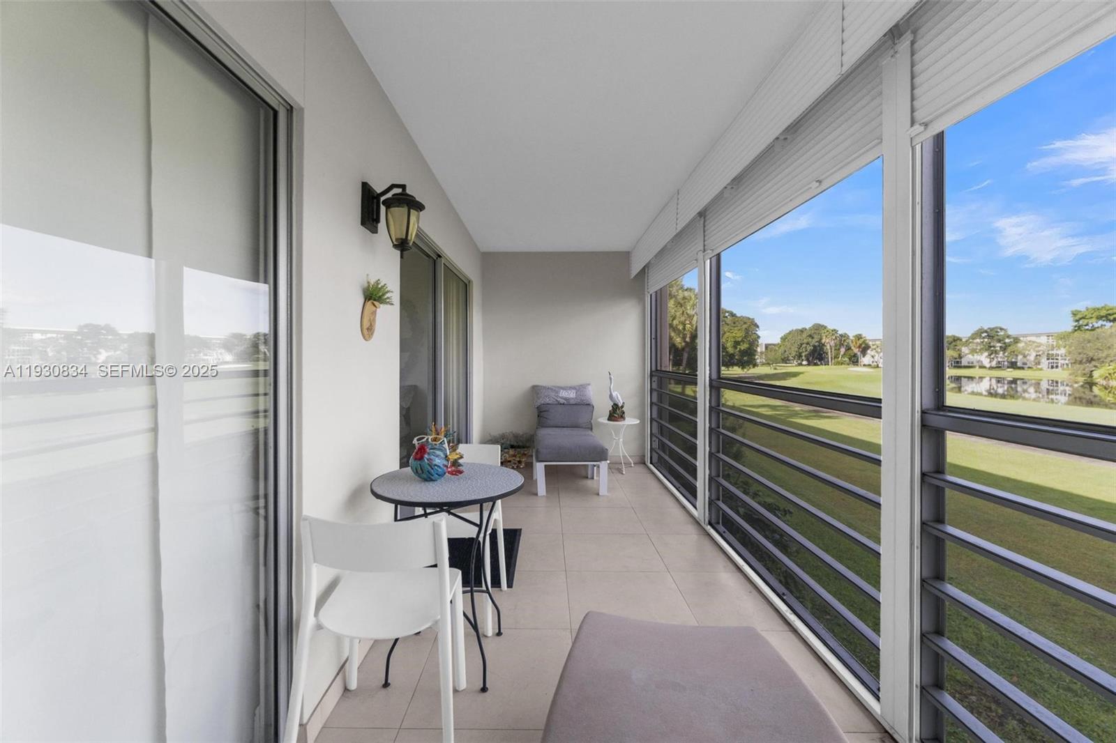 4402 Martinique Court, Unit K2 Coconut Creek, FL 33066 - Photo 29 of 38 a view of a room with a table and chairs