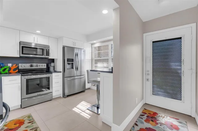 a kitchen with stainless steel appliances a stove a microwave and a refrigerator