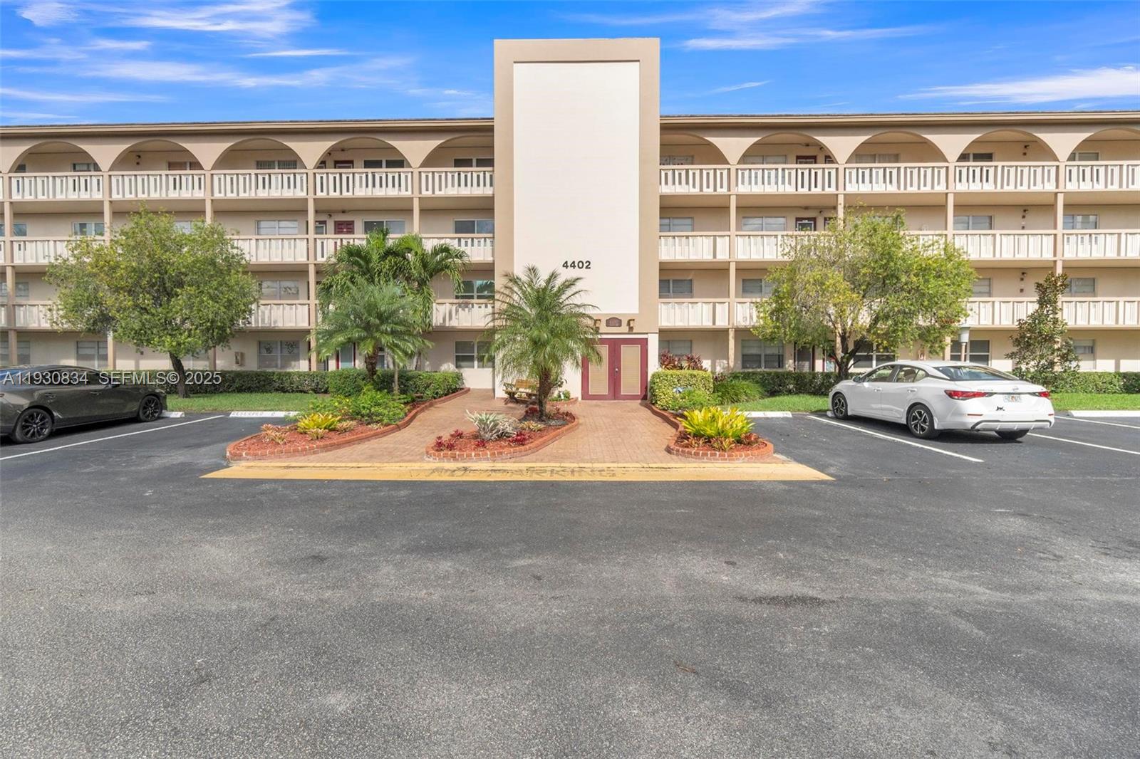 4402 Martinique Court, Unit K2 Coconut Creek, FL 33066 - Photo 32 of 38 a view of parking with a car parked in front of it