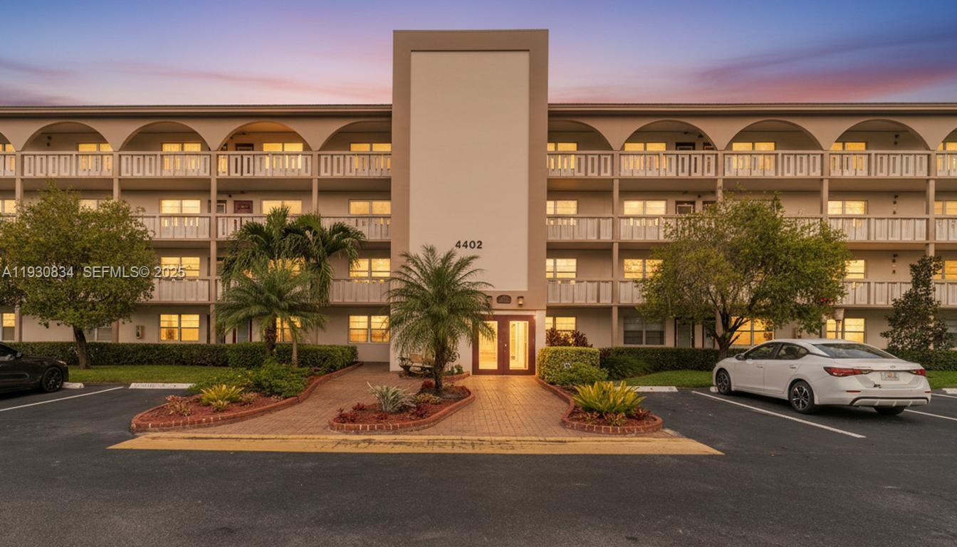 4402 Martinique Court, Unit K2 Coconut Creek, FL 33066 - Photo 38 of 38 a couple of cars parked in front of a building