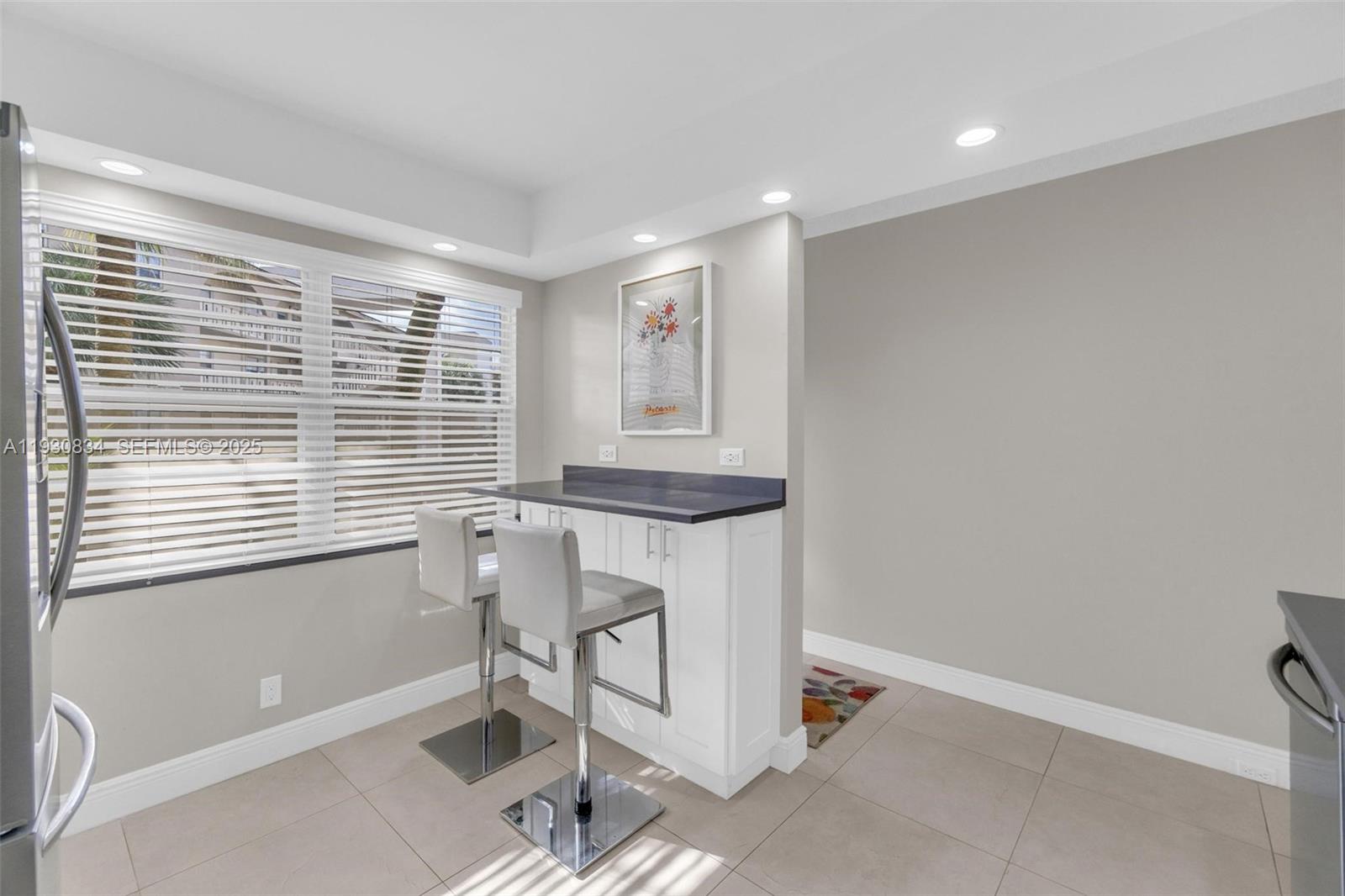 4402 Martinique Court, Unit K2 Coconut Creek, FL 33066 - Photo 8 of 38 a workspace with furniture and a window