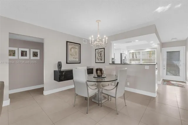 a view of a dining room with furniture and chandelier
