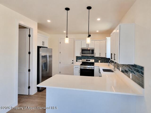 511 Last Chance Drive Rifle, CO 81650 - Photo 5 of 14 a kitchen with kitchen island a refrigerator a sink and wooden floor