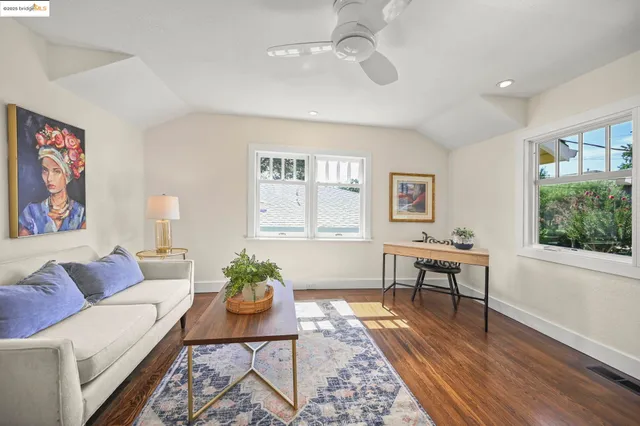 a living room with furniture a window and a potted plant
