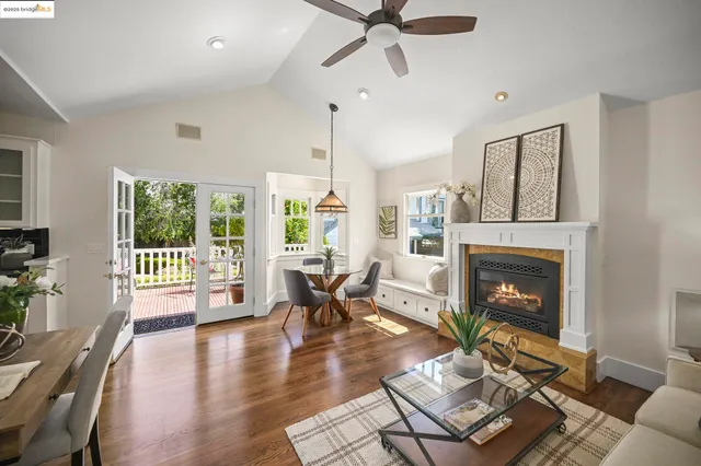 a living room with furniture large window and a fireplace