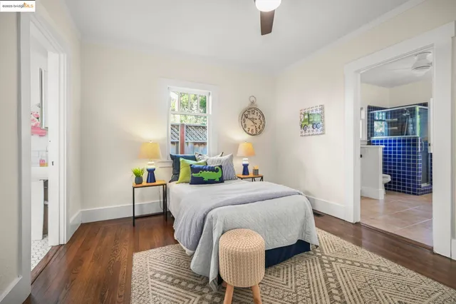 a bedroom with a bed and a table with wooden floor