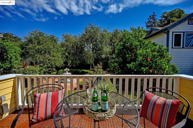 a view of a chair and table on the wooden deck