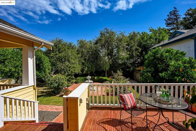 a view of a chairs and table in the balcony