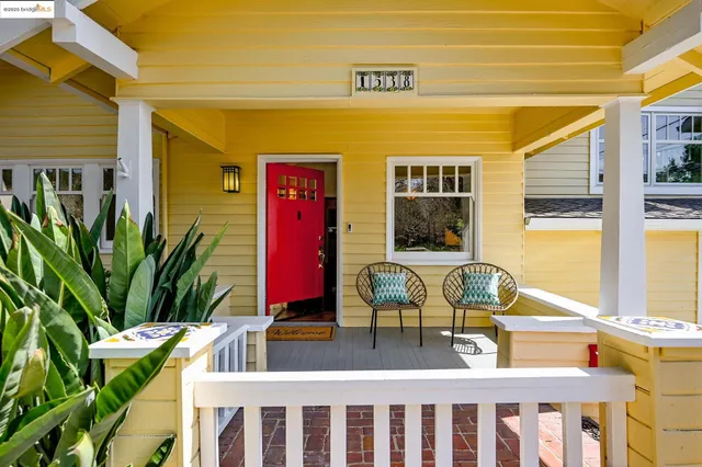 a view of balcony with two chairs and a potted plant