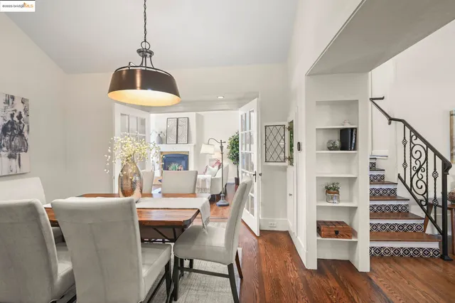 a view of a dining room with furniture a chandelier and wooden floor
