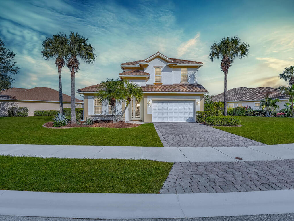 a front view of a house with a yard and garage