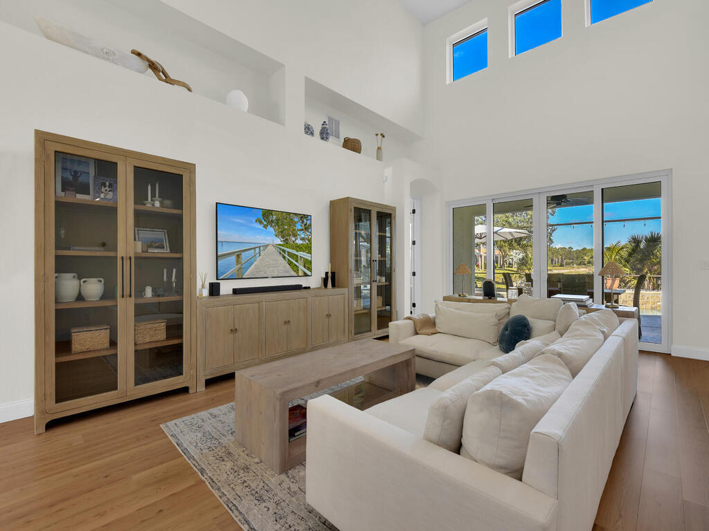 7851 Founders Circle Naples, FL 34104 - Photo 11 of 43 a living room with furniture and a floor to ceiling window