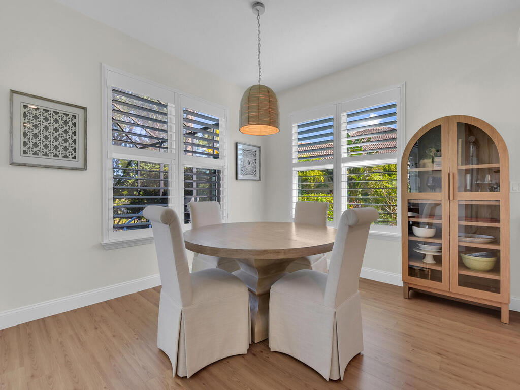 7851 Founders Circle Naples, FL 34104 - Photo 13 of 43 a view of a dining room with furniture window and wooden floor