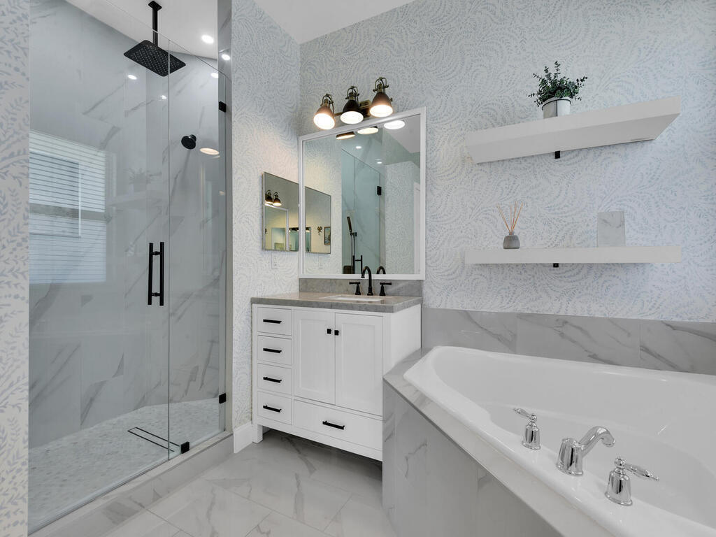 7851 Founders Circle Naples, FL 34104 - Photo 20 of 43 a bathroom with a bathtub sink and mirror