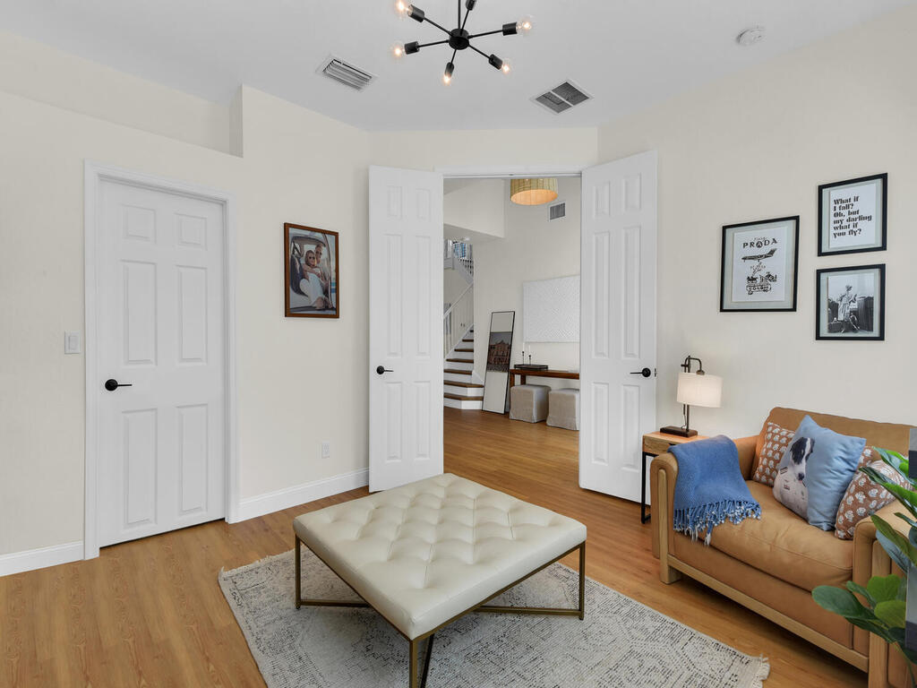 7851 Founders Circle Naples, FL 34104 - Photo 23 of 43 a living room with furniture and wooden floor