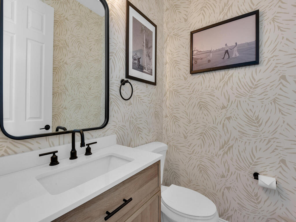 7851 Founders Circle Naples, FL 34104 - Photo 25 of 43 a bathroom with a sink mirror vanity and toilet
