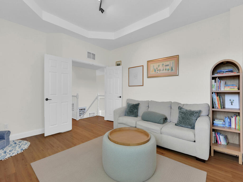 7851 Founders Circle Naples, FL 34104 - Photo 29 of 43 a living room with furniture and a book shelf