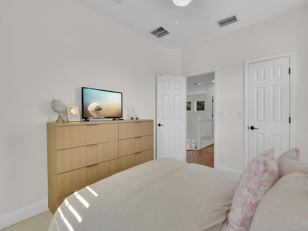 7851 Founders Circle Naples, FL 34104 - Photo 33 of 43 a bedroom with a bed and a lamp on the dresser