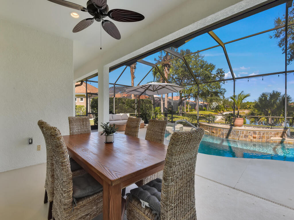7851 Founders Circle Naples, FL 34104 - Photo 35 of 43 a view of a dining room with furniture and a floor to ceiling window
