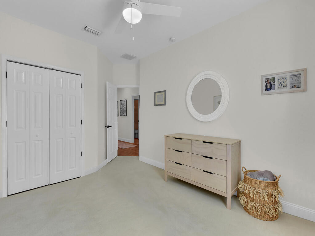 7851 Founders Circle Naples, FL 34104 - Photo 36 of 43 a room with a dresser and a mirror