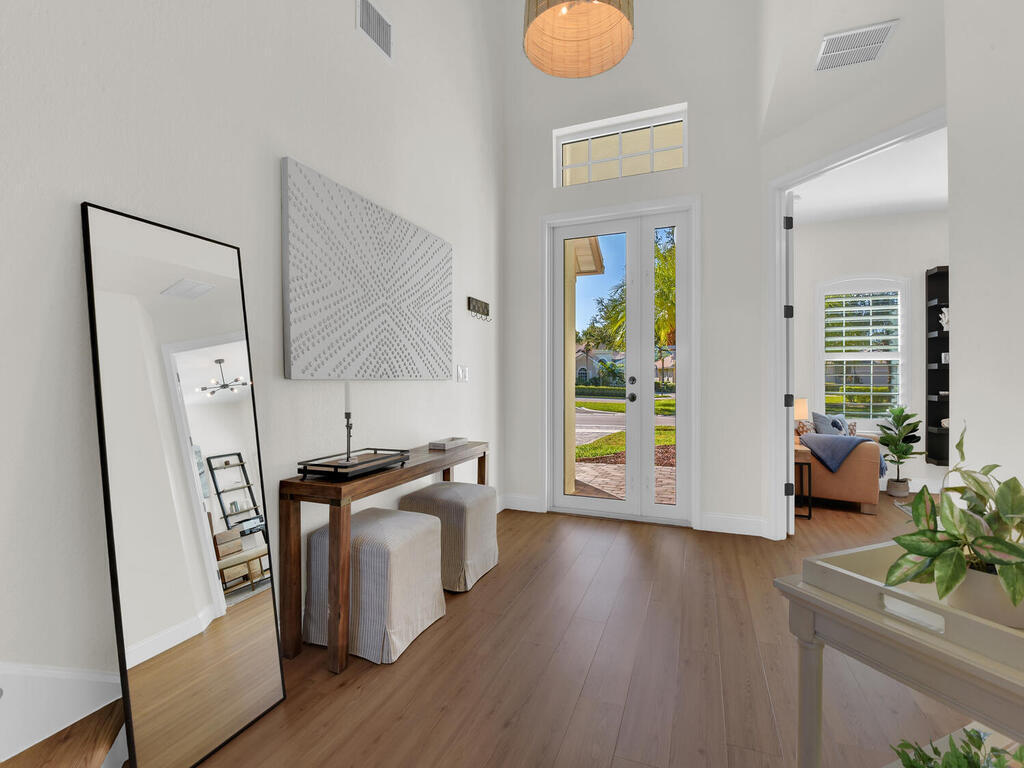 7851 Founders Circle Naples, FL 34104 - Photo 5 of 43 a view of a kitchen with fridge and wooden floor