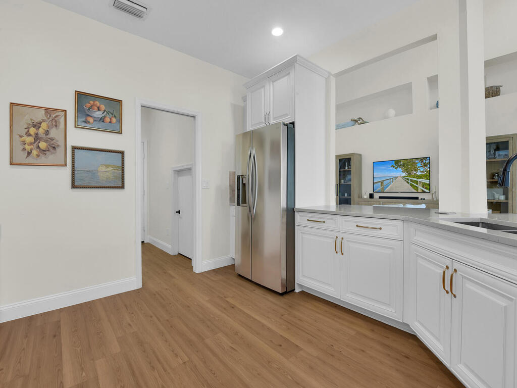 7851 Founders Circle Naples, FL 34104 - Photo 9 of 43 a kitchen with a refrigerator and a sink