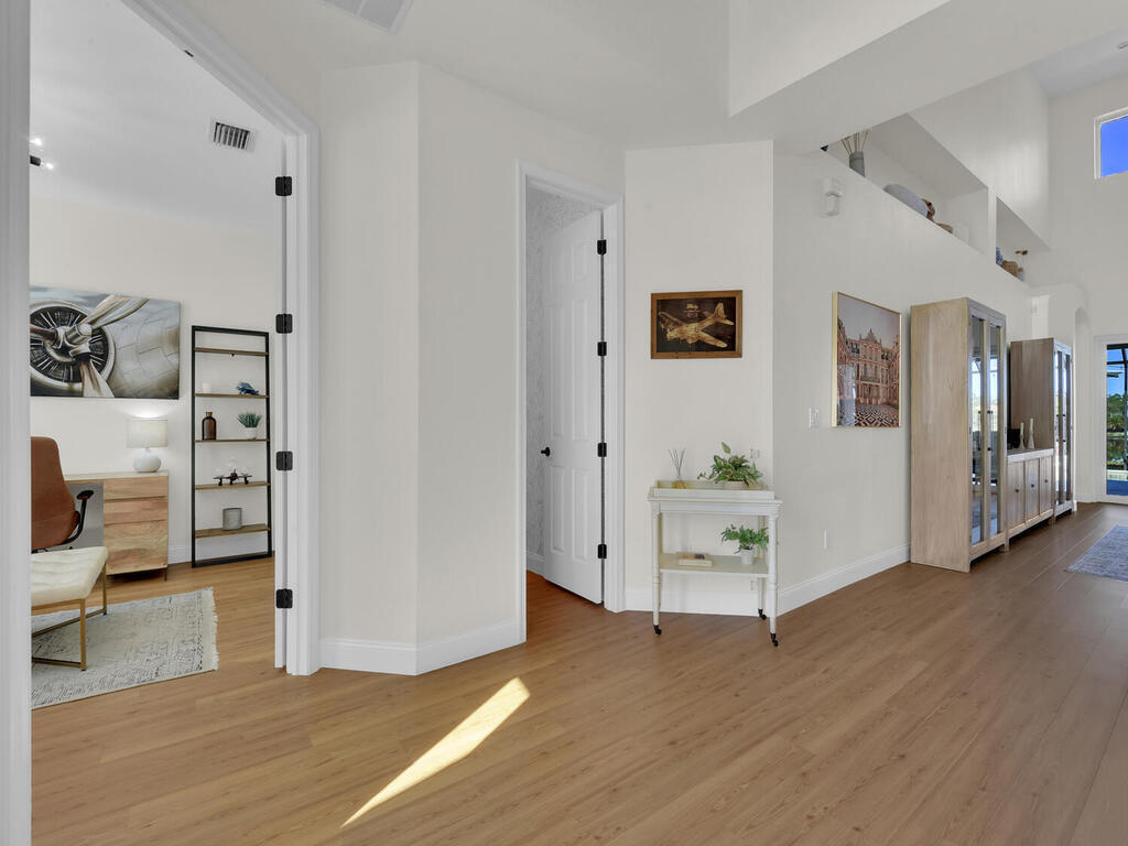7851 Founders Circle Naples, FL 34104 - Photo 10 of 43 a view of a livingroom with wooden floor and furniture