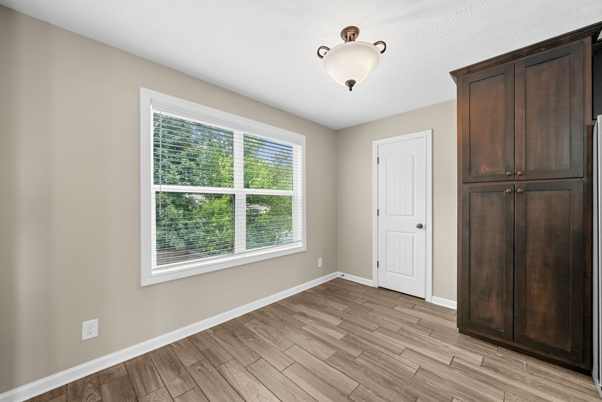 1227 Brigade Drive Clarksville, TN 37043 - Photo 8 of 39 an empty room with wooden floor and windows