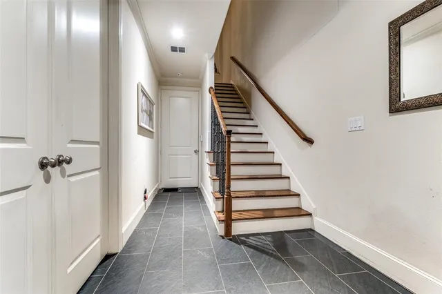 a view of a hallway with entryway and stairs