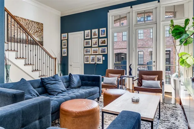 a living room with furniture fireplace and a large window