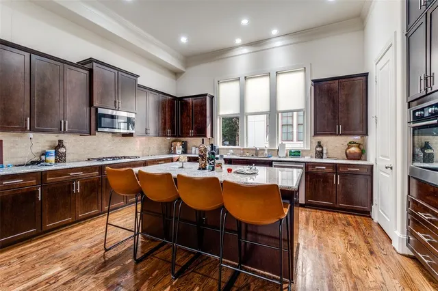 a kitchen with a sink appliances and cabinets